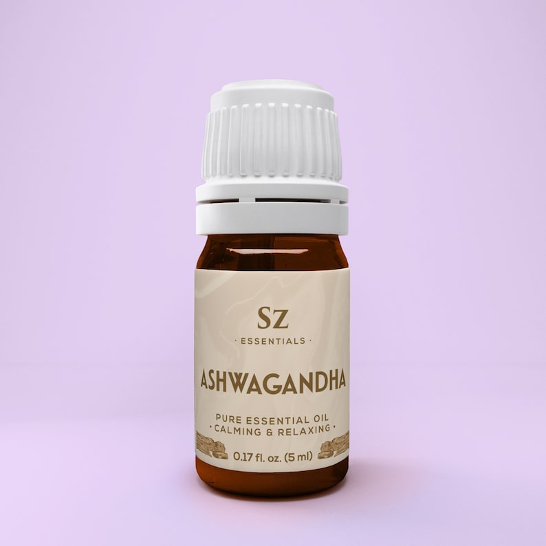 May include: A brown glass bottle with a white cap, labeled "Sz Essentials Ashwagandha Pure Essential Oil &bull;Calming & Relaxing&bull; 0.17 fl. oz. (5 ml)"