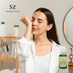 May include: A woman is smelling a small bottle of Kaffir Lime Leaf essential oil from SZ Essentials. The bottle is green and white with a white cap. The label says "SZ Essentials Kaffir Lime Leaf Pure Essential Oil Citrus Hystrix 0.25 fl oz (7.5 ml)"