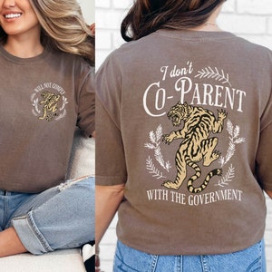May include: Brown t-shirt with a tiger graphic and the text "I don't Co-Parent with the Government".