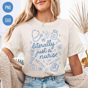 May include: Cream-colored t-shirt with a blue medical-themed design. The design includes a stethoscope, bandages, pills, and the text "literally just a nurse". The shirt is a casual style.