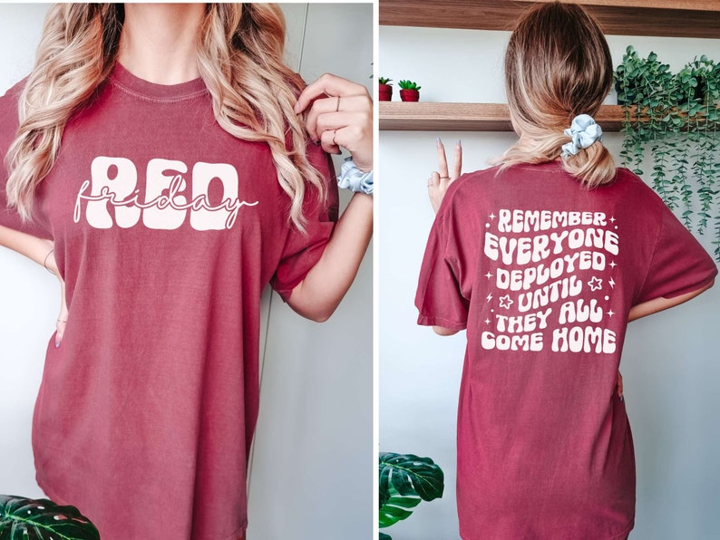 May include: A maroon t-shirt with white text. The front of the shirt says "RED friday" in a retro font. The back of the shirt says "REMEMBER EVERYONE DEPLOYED UNTIL THEY ALL COME HOME" in a retro font.