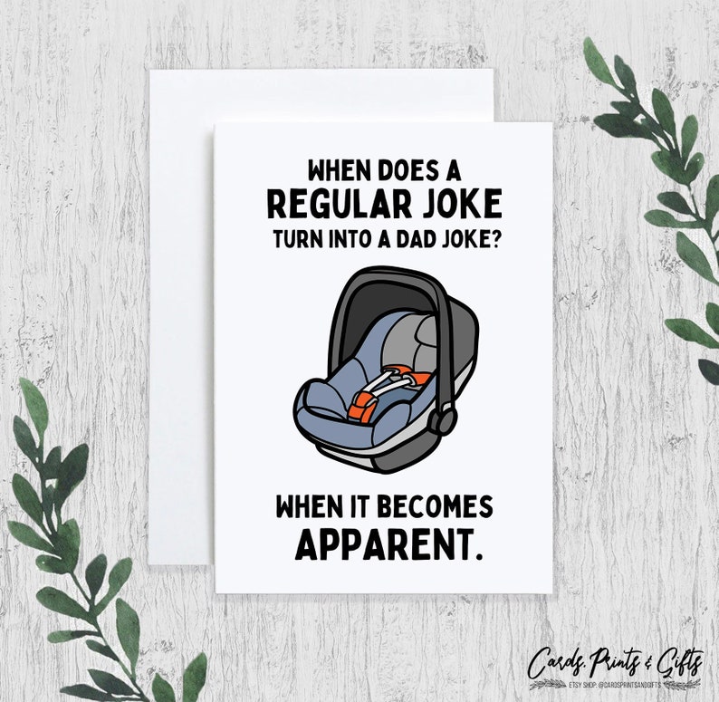 May include: A white card with black text that reads "When does a regular joke turn into a dad joke?" and "When it becomes apparent."  A black and white illustration of a car seat is in the centre of the card.