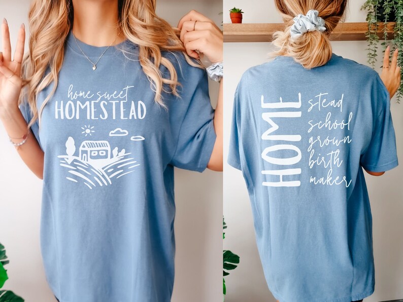May include: A light blue t-shirt with a white graphic on the front that says "home sweet homestead" and a white graphic on the back that says "HOME stead school grown birth maker".