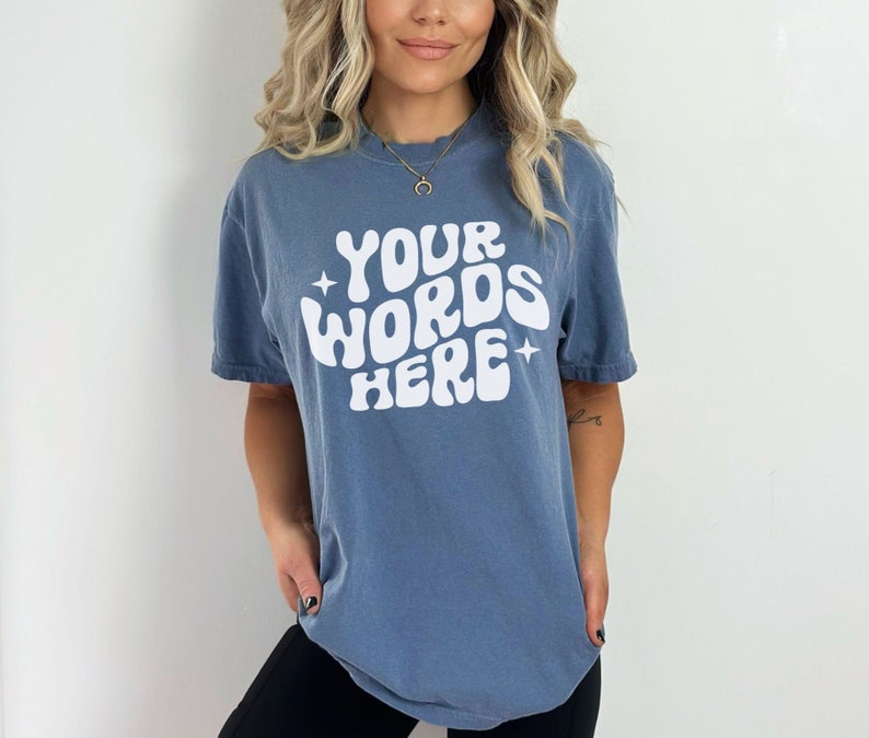 May include: A blue t-shirt with the text "YOUR WORDS HERE" in white, stylised lettering.