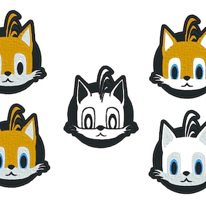 May include: Six embroidered patches featuring the face of a cartoon fox with a white background and black outlines. The fox has orange fur, blue eyes, and a white muzzle. Three of the patches have a black background, and three have a white background.