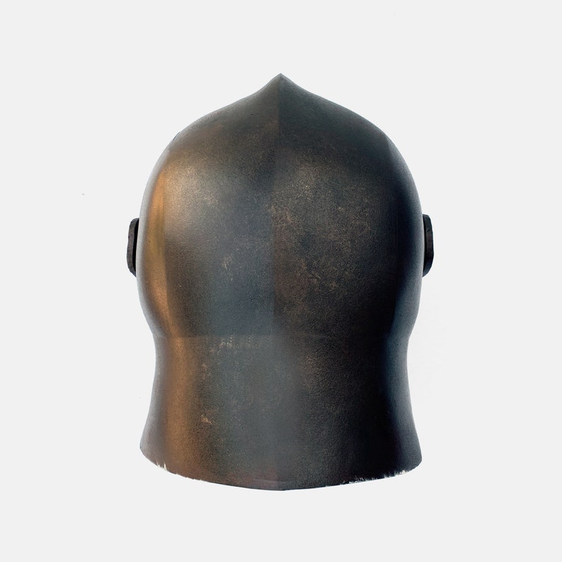 May include: A dark brown helmet with a rounded top and a smooth, slightly textured surface. The helmet has two small, round ear pieces on either side.