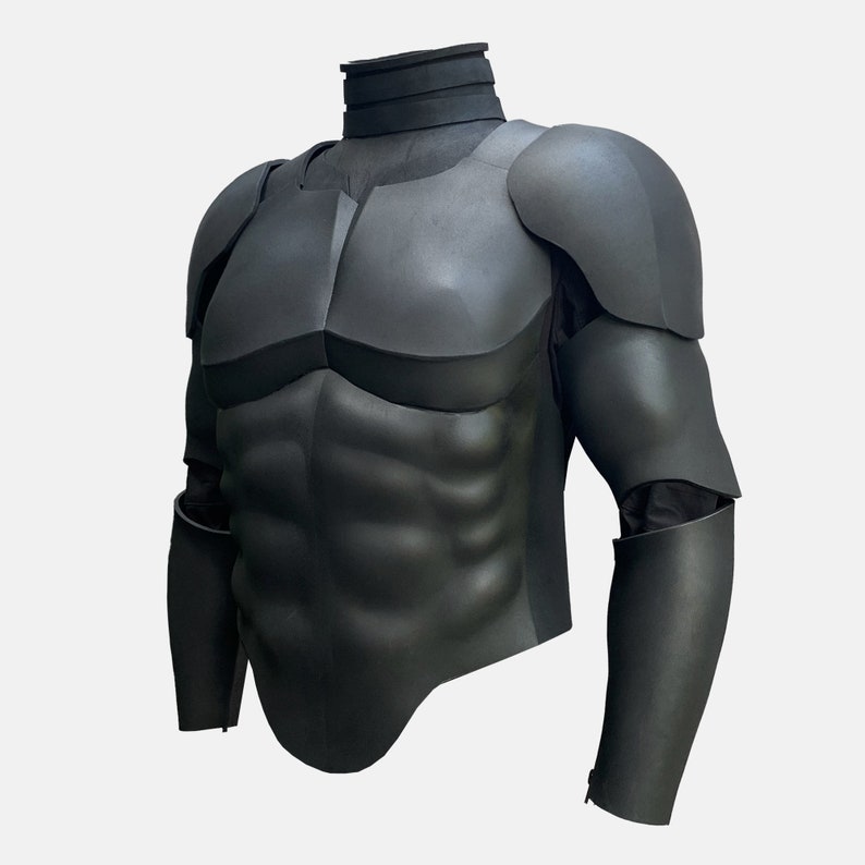 May include: Black foam armor for cosplay or costume. The armor features a sculpted chest piece with defined muscle lines and a matching set of arm pieces.