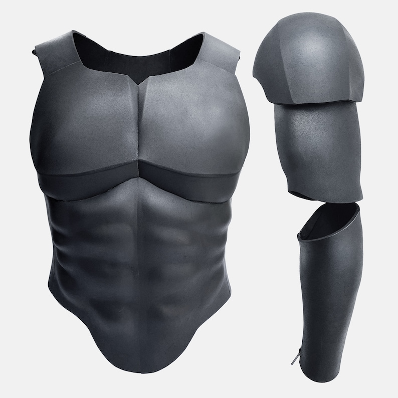 May include: Black foam armor for cosplay or costume. The armor includes a chest piece with a sculpted muscle design and a separate arm piece.