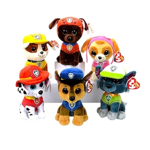 May include: A collection of plush toy dogs, each with large eyes and wearing different uniforms. The toys are in various colors, including red, yellow, blue, and green. Each toy has a tag attached.