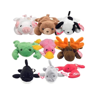 May include: A selection of plush animal toys, featuring a white pig, brown bear, black and white dog, green frog, pink platypus, brown moose, black orca, grey dolphin, and red lobster. Each toy has a tag attached.