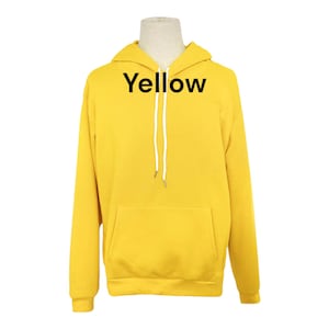 May include: A yellow hooded sweatshirt with the word "Yellow" printed on the front.