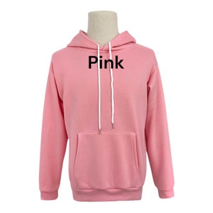 May include: A pink hoodie with a white drawstring and the word "Pink" printed on the front.