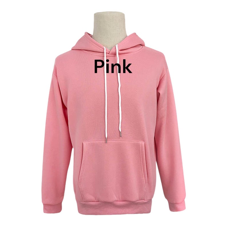 May include: A pink hoodie with a white drawstring and the word "Pink" printed on the front.