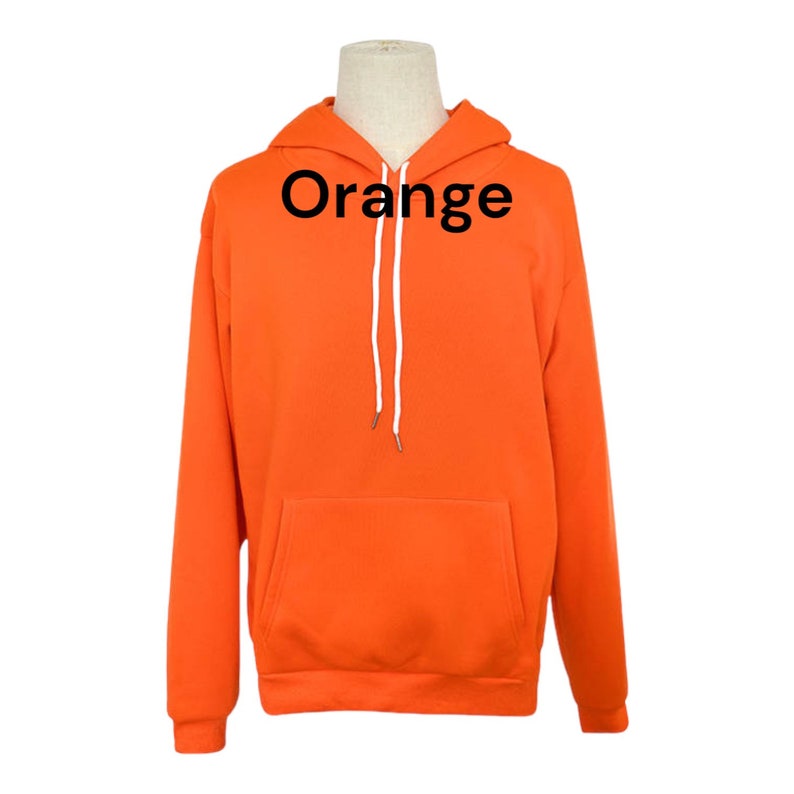 May include: Orange hoodie with a white drawstring. The hoodie has a kangaroo pocket.