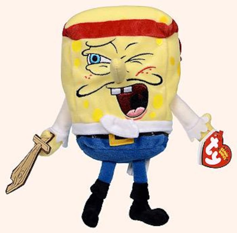 Peut inclure: Peluche de Bob l'&eacute;ponge en costume de pirate. Le personnage &eacute;ponge jaune porte un bandana rouge, un clin d'&oelig;il et une &eacute;p&eacute;e en bois. Il porte une tenue bleue avec une boucle dor&eacute;e et des bottes noires. Une &eacute;tiquette Ty Beanie Baby est attach&eacute;e.