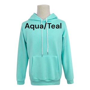 May include: A teal blue hooded sweatshirt with the text "Aqua/Teal" printed on the front.