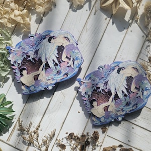 May include: Two circular metal pins with a blue, purple, and white design. The pins feature a winged figure with the text "For You I'm Yours" on each pin.