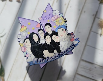 May include: Purple and blue enamel pin with a cartoon illustration of seven people, with the text "ARMY X BTS FOREVER" and "11th Anniversary".