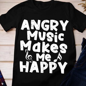 May include: Black t-shirt with the white text "ANGRY MUSIC Makes & me HAPPY". The design includes musical notes and a treble clef. The shirt is made of a soft material.