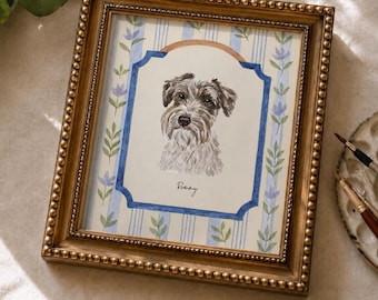 May include: A framed watercolour portrait of a Schnauzer dog. The artwork is set within a gold-coloured, beaded frame. The background features blue stripes and floral accents. The dog's name, "Rainy", is written below the portrait.