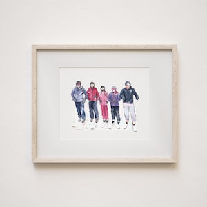 May include: A framed watercolor illustration depicting five individuals standing in a row, dressed in winter ski gear including helmets, goggles, jackets, and pants, with skis and poles visible, all presented within a light-colored wooden frame.