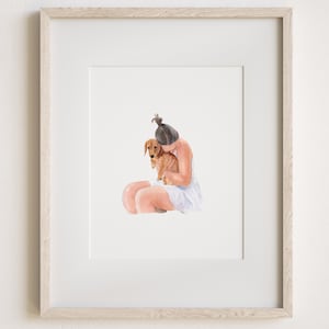 May include: A framed watercolor illustration featuring a person with dark hair tied in a top knot, wearing a white sleeveless garment, sitting and embracing a small brown dachshund dog. The artwork is encased in a light-toned wooden frame.