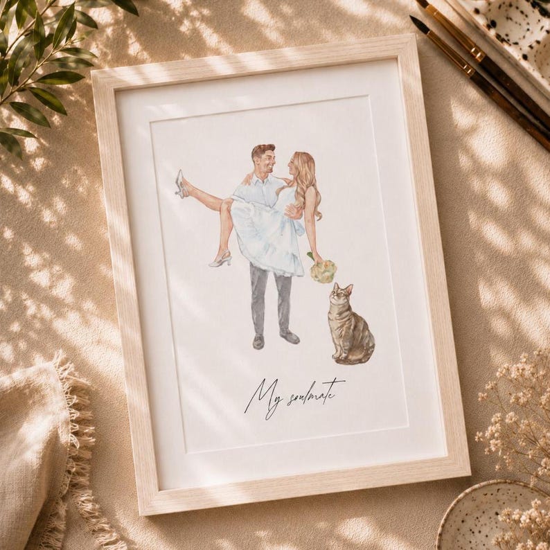 May include: A framed watercolor illustration featuring a person in a light blue shirt and gray trousers carrying another person in a white dress and white heels, with a brown tabby cat and the handwritten text My soulmate below the figures.