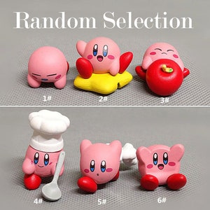 May include: A collection of six pink Kirby figurines with various poses and accessories. One figurine is on a yellow star, another holds a red apple, and one wears a chef's hat and holds a spoon. The text "Random Selection" is at the top.