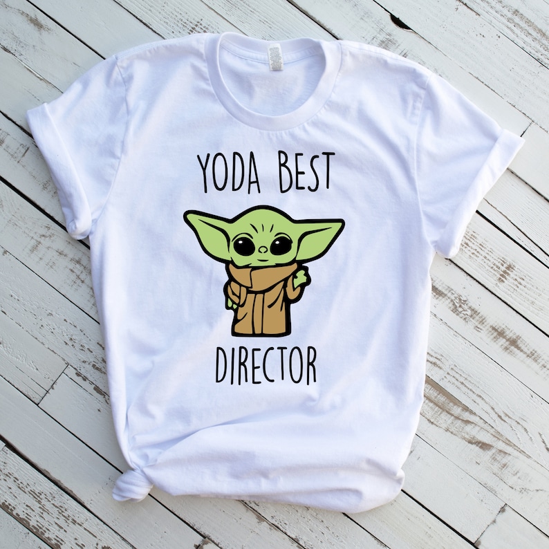 May include: White t-shirt with a green cartoon character and the text "Yoda Best Director".