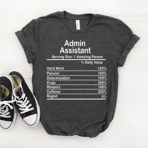 May include: Dark grey t-shirt with a white graphic that reads "Admin Assistant" and lists the daily value of various qualities, such as hard work, passion, determination, pride, respect, caffeine, and regret.