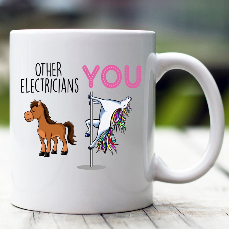 May include: White ceramic coffee mug with a pink and white unicorn graphic and the text "Other Electricians You".