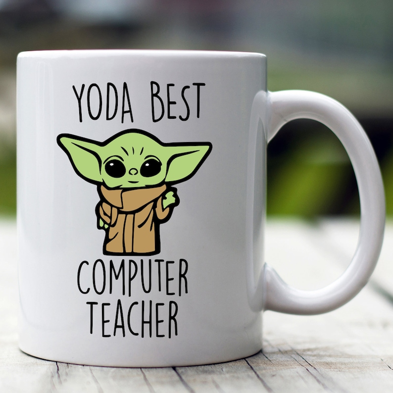 May include: White ceramic mug with a green cartoon character and the text "YODA BEST COMPUTER TEACHER".