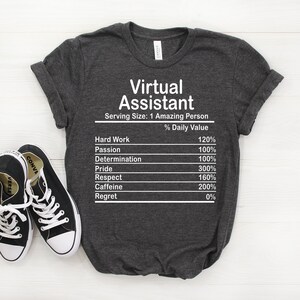 May include: A dark gray t-shirt with the text "Virtual Assistant" and a nutrition facts label listing the percentage daily value of hard work, passion, determination, pride, respect, caffeine, and regret.