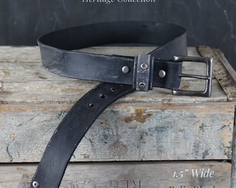 May include: A 1.5" wide black leather belt with a silver buckle and rivets. The belt is distressed and has a "Relic Black" finish. The belt is part of the "Heritage Collection".