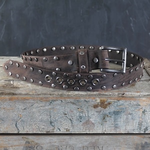 Aged Leather Belt Studded. Grommets accent 1.5 inches wide. Dark Brown
