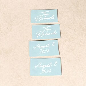 May include: Four light blue cards with white text. The top two cards say "The Richards". The bottom two cards say "August 8, 2024".