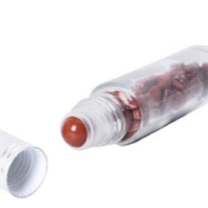 May include: A clear glass roller bottle with a white cap and a red roller ball. The bottle is filled with small, red, irregularly shaped stones.