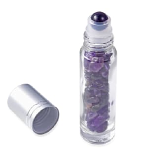 May include: A clear glass roller bottle filled with amethyst crystals and a silver cap. The bottle has a roller ball applicator.