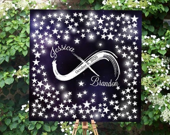 Puede incluir: Un lienzo negro con estrellas blancas y un símbolo de infinito con los nombres Jessica y Brandon y la fecha 8 de octubre de 2020. El lienzo está en un caballete de madera.