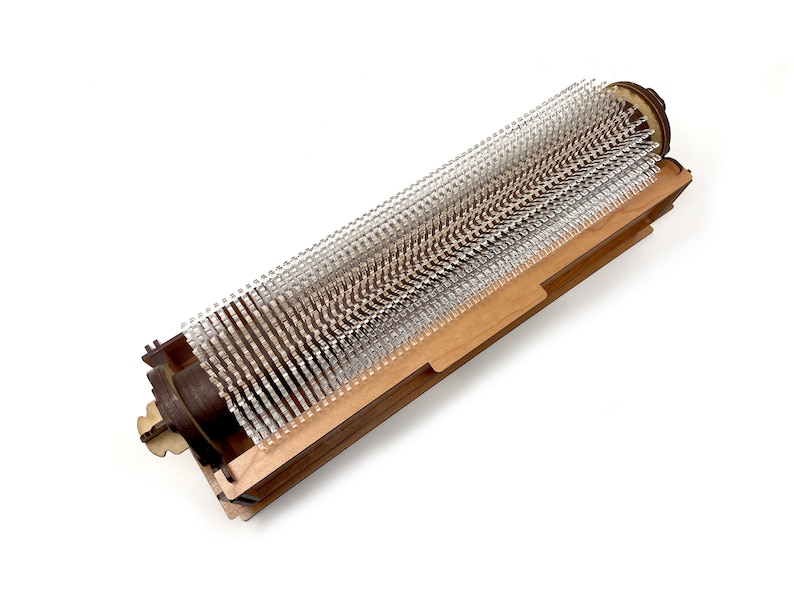 May include: A wooden frame with a clear plastic brush roller inside. The roller is made of many small, clear plastic bristles.