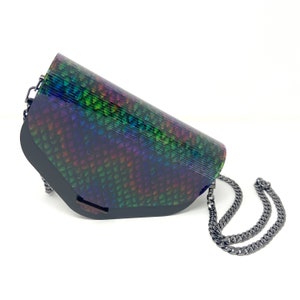 Puede incluir: Un bolso bandolera negro iridiscente con una correa de cadena. El bolso tiene un patr&oacute;n texturizado, escamoso y una forma curva.