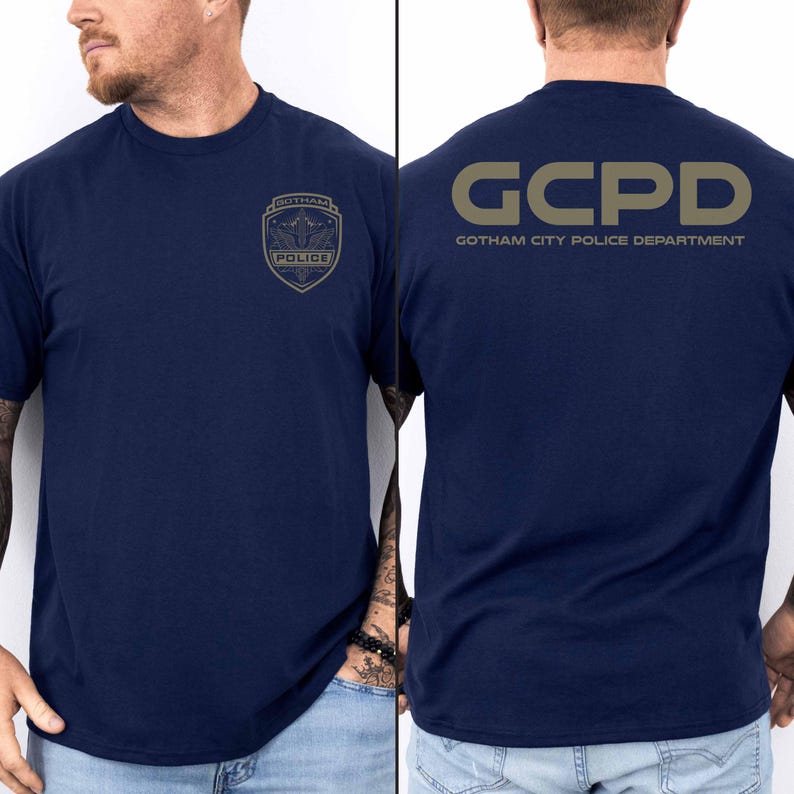 May include: A navy blue t-shirt with a gold GCPD Gotham City Police Department logo on the back and a gold Gotham Police badge on the front.
