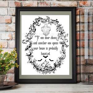 May include: Black and white printable Halloween sign with a spooky ghost and bats. The sign reads "If one door closes and another one opens your house is probably haunted."