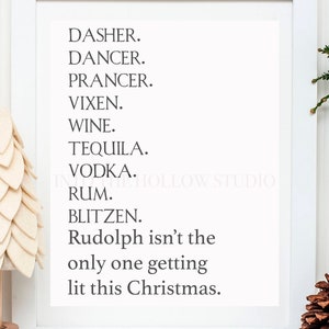 May include: A white framed print with black text that reads "Dasher. Dancer. Prancer. Vixen. Wine. Tequila. Vodka. Rum. Blitzen. Rudolph isn't the only one getting lit this Christmas."