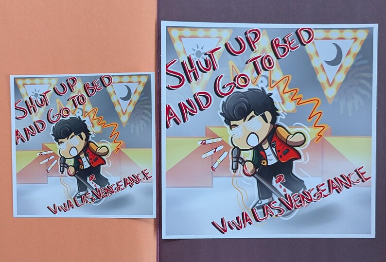 May include: Two square prints featuring a cartoon character with a microphone, wearing a red jacket and sunglasses. The text "SHUT UP AND GO TO BED" and "VIVA LAS VENGEANCE" are written in red. The background has a stage-like design.