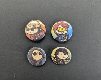 May include: Four round pinback buttons with cartoon illustrations of characters wearing sunglasses and various outfits. The buttons have a glossy finish and are set against a dark background.