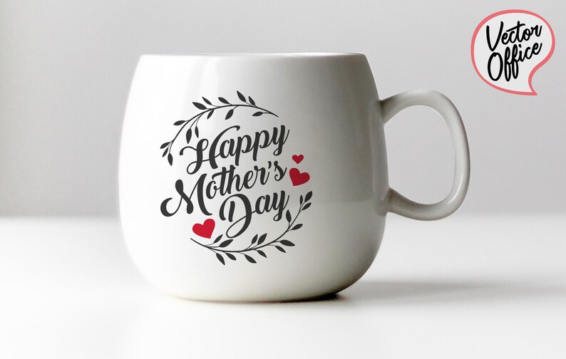 May include: White ceramic mug with a black and white design that says "Happy Mother's Day" with a wreath of leaves and three red hearts.