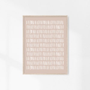 May include: A framed print with a minimalist design featuring a pattern of white dashes on a light pink background.
