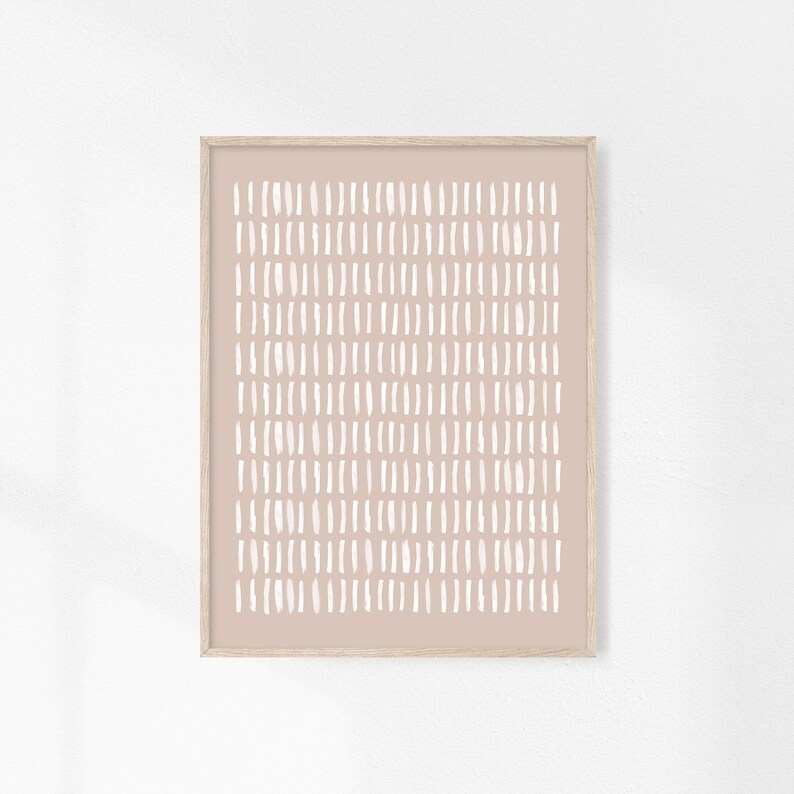 May include: A framed print with a minimalist design featuring a pattern of white dashes on a light pink background.