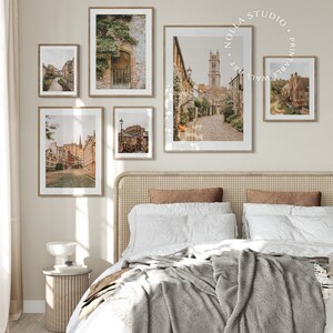 May include: A collection of five framed prints featuring vintage photographs of a European city. The prints are arranged in a grid pattern on a light beige wall above a wicker headboard bed.